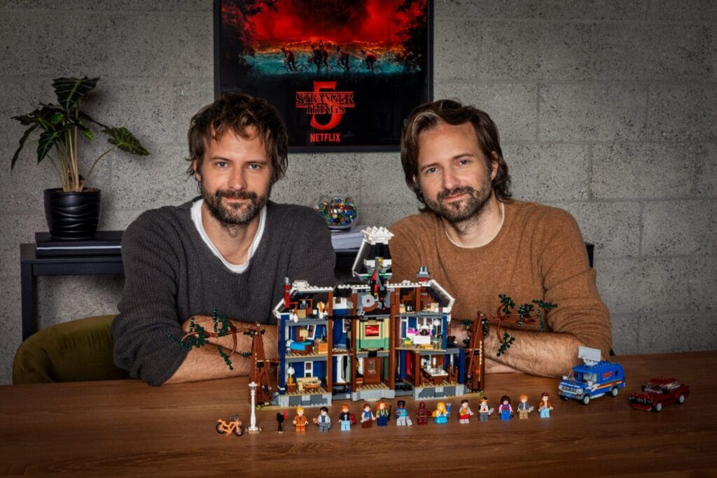 LEGO Stranger Things Creel House: The Amazing Transforming LEGO House Arrives January 2026 3 The Duffer Brothers pose with the Stranger Things The Creel House model