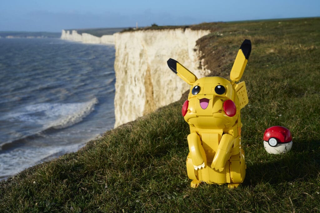 From the new LEGO Pokemon Sets, the brick-built Pikachu and Poké ball sit on a cliff.