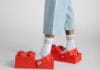 LEGO Crocs Collaboration Is Happening: Brick-Shaped Clogs Are Coming A close up of the new LEGO Crocs collaboration on a mans feet.