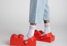 LEGO Crocs Collaboration Is Happening: Brick-Shaped Clogs Are Coming A close up of the new LEGO Crocs collaboration on a mans feet.