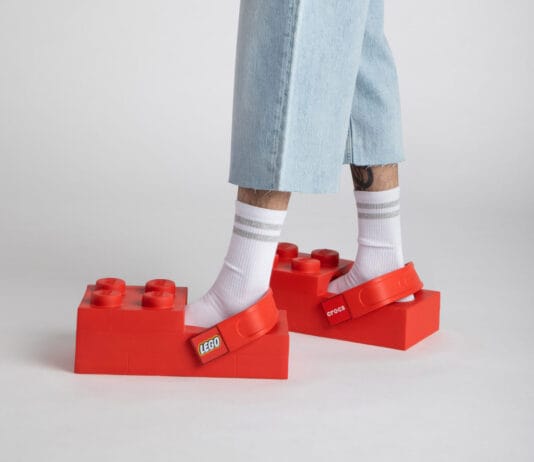 LEGO Crocs Collaboration Is Happening: Brick-Shaped Clogs Are Coming A close up of the new LEGO Crocs collaboration on a mans feet.